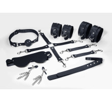 Набір Feral Feelings BDSM Kit 7 Black, наручники, поножі, конектор, маска, падл, кляп, затискачі